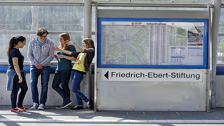 Young students standing at a underground rail station in Berlin.