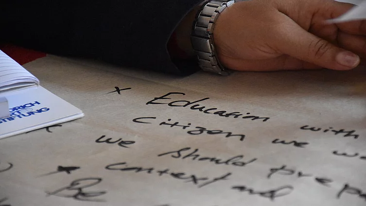 Handwritten notes on paper that appear to relate to education and civic engagement.